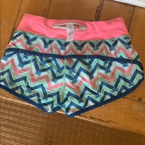 Green, blue, and pink Ivivva speedy short shorts.